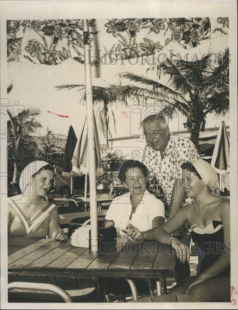 1957 Mrs. MArtin Walters with her Family relaxing in the sun. - Historic Images