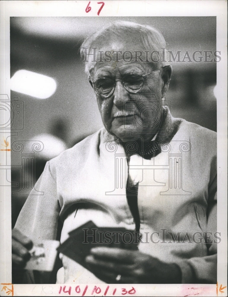 1957 Richard T. Bowman holding a cards. - Historic Images