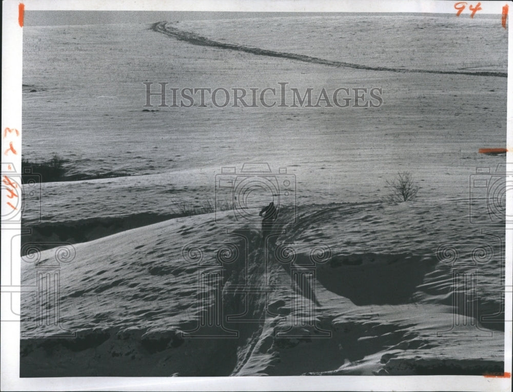 1974 Man walking on Snow - Historic Images