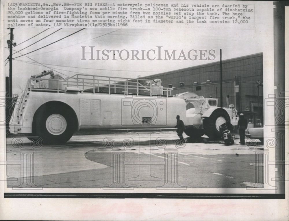 1966 Motorcycle policeman and his vehicle worlds largest firetruck - Historic Images