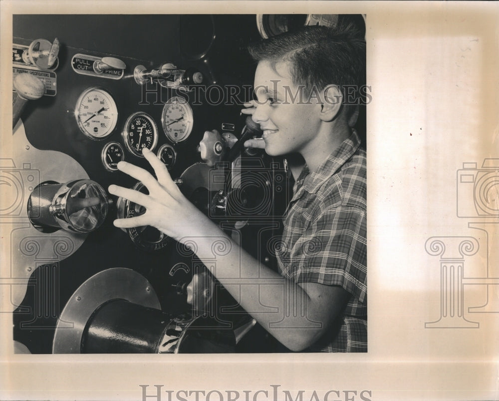 Press Photo Child Plays With Firetruck Guages - Historic Images