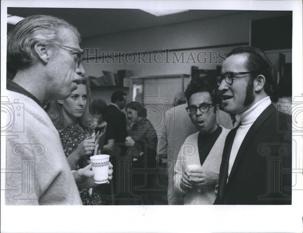 1970 group of men and woman standing conversing - Historic Images