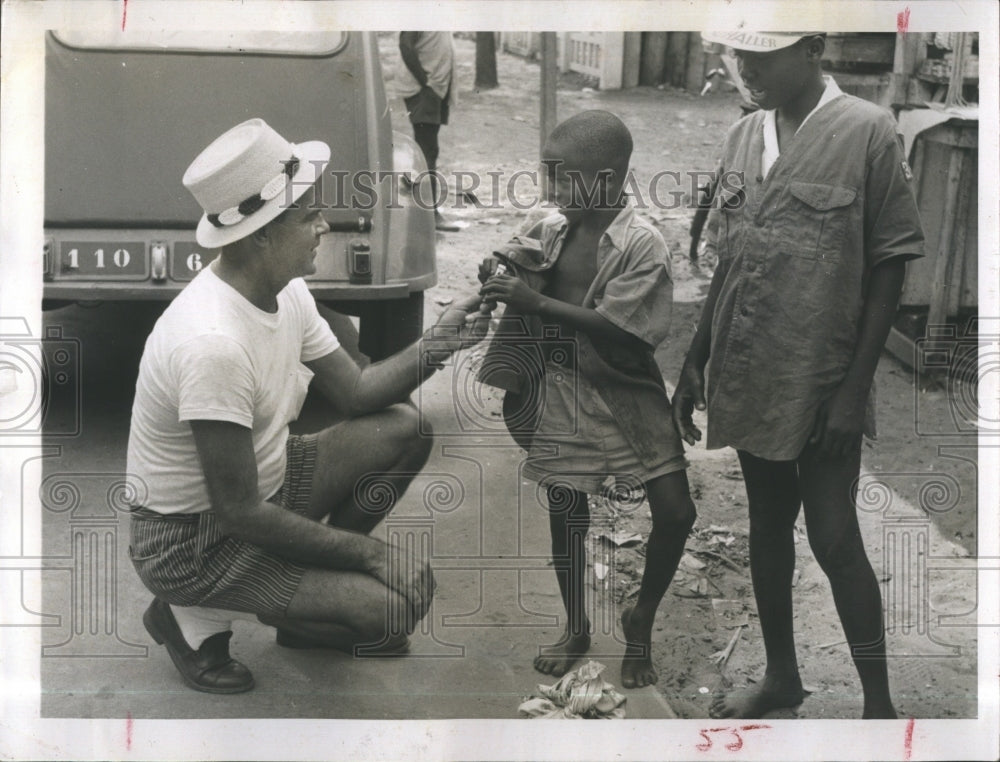 1959 C Winn Upchurch makes friends with native children - Historic Images