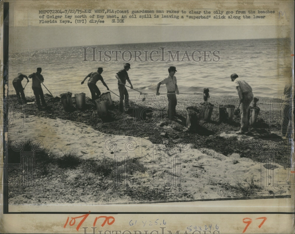 1975 coast guardsman rakes oily goo beaches Geiger Key Key West - Historic Images