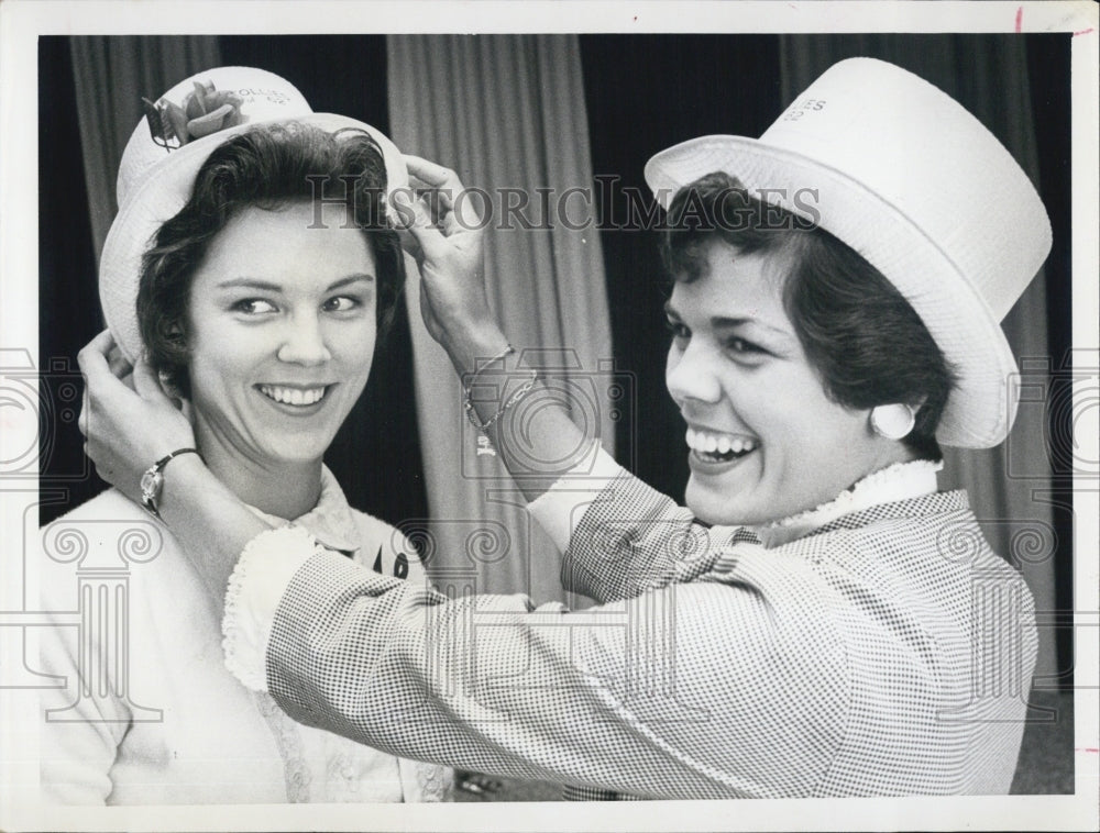 1962 Miss Patricia Helen Mack receives help adjusting her hat-Historic Images