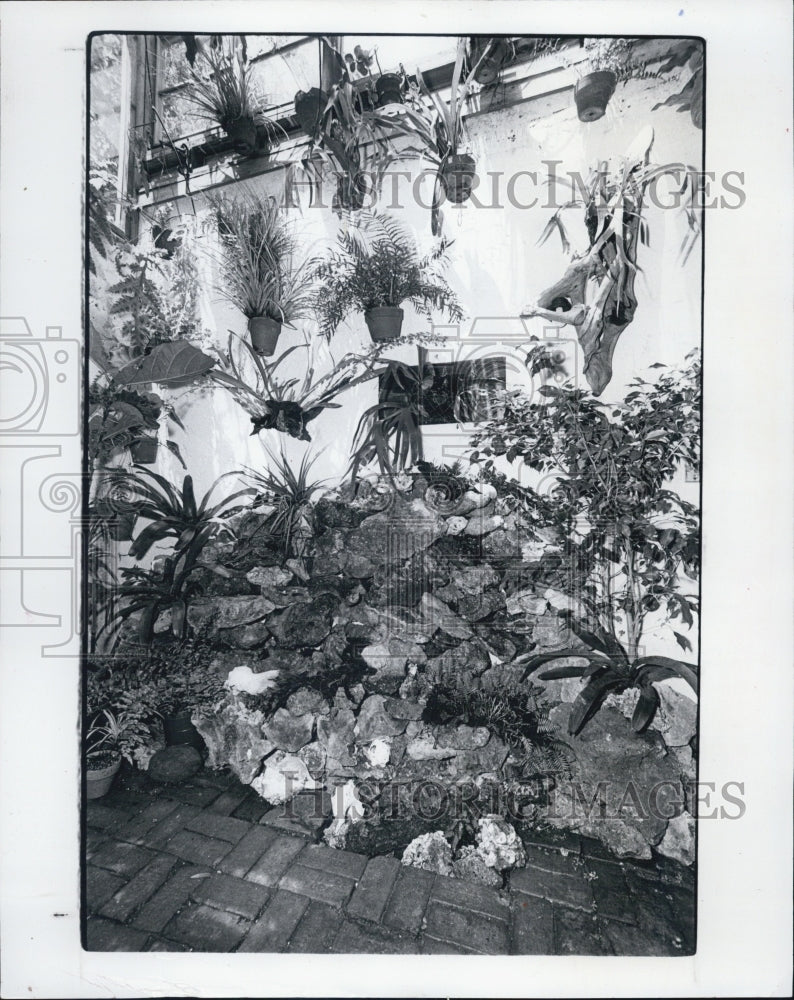 1982 Press Photo Water Trickling From Hose Concealed Behind Rock Garden - Historic Images