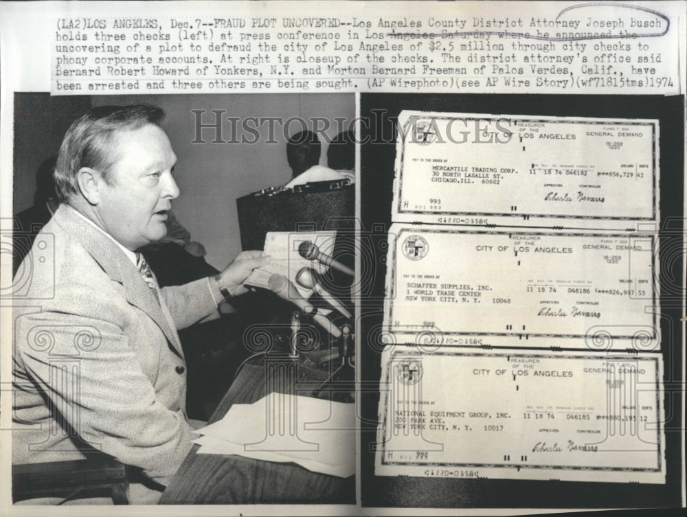 1974 Press Photo Atty. Joseph Busch holds three checks - Historic Images