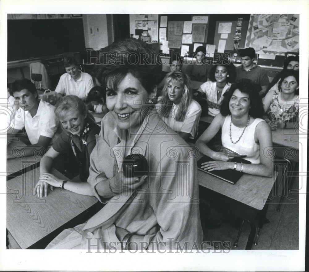 1988 Press Photo Woman holding an apple inside a classroom - Historic Images