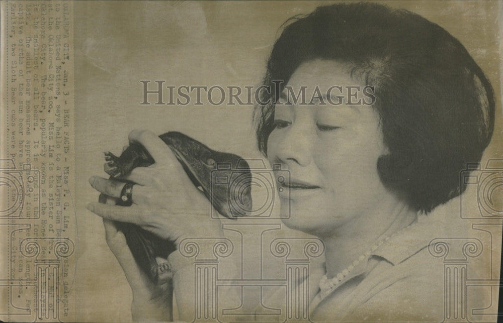 Press Photo Miss P.G Lim holds a Malayan Sun Bear. - Historic Images