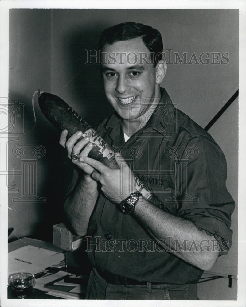 1967 Press Photo Navy Lt. Stephen Placker holds a salami. - Historic Images