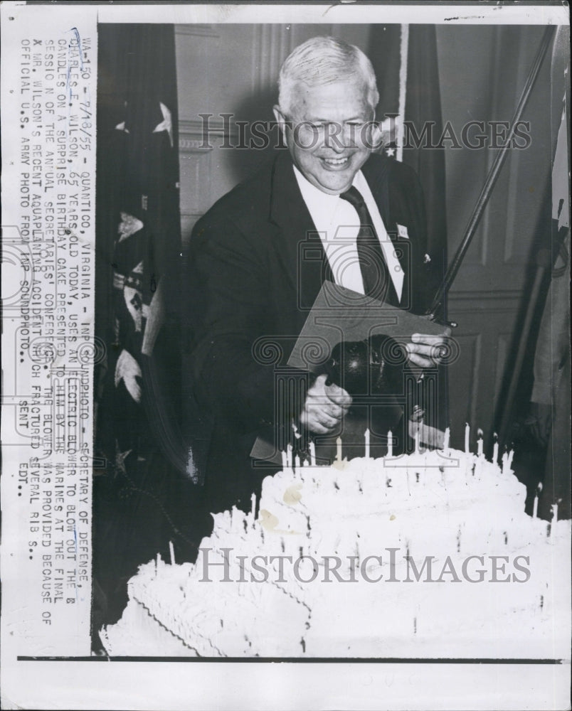 1955 Press Photo Sec. of Defense Charles E. Wilson, blower his birthday cake. - Historic Images