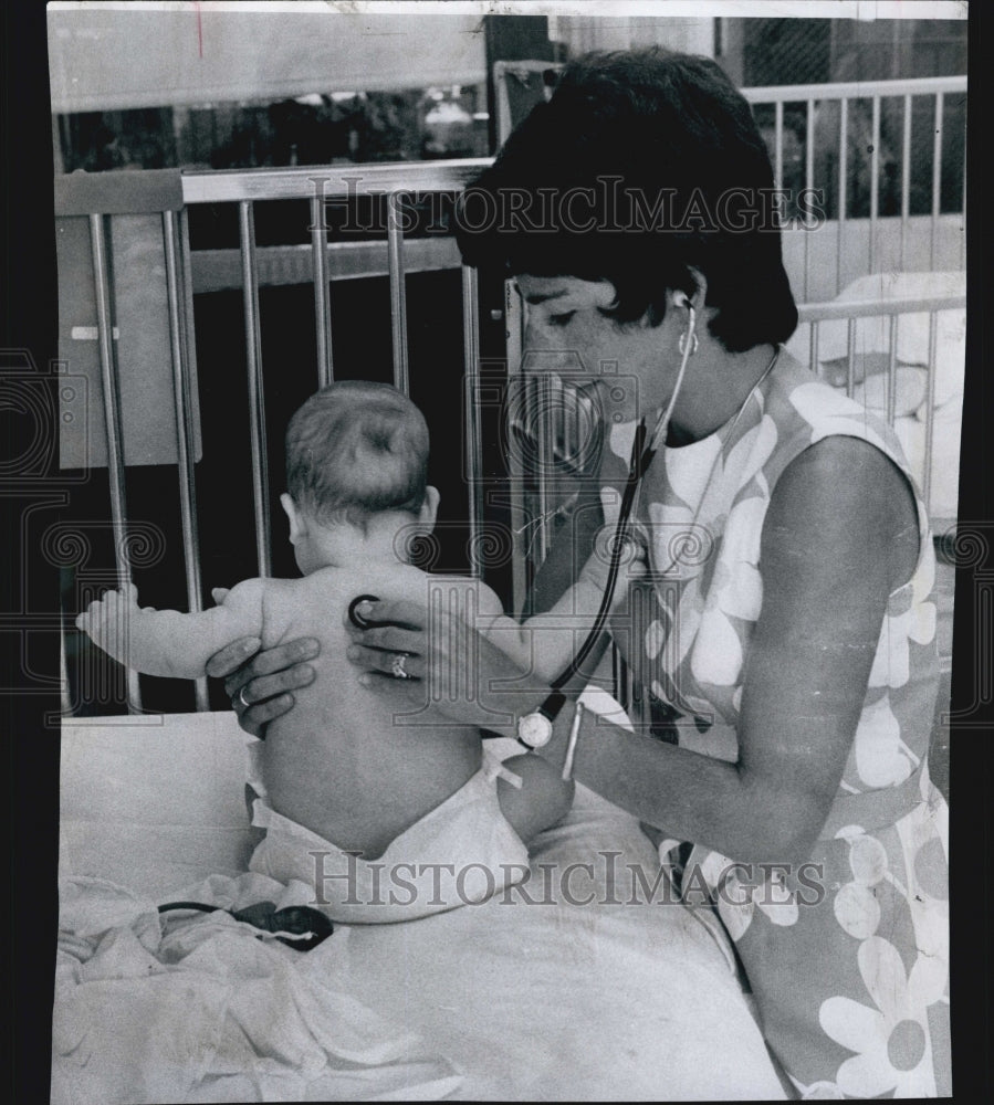 1974 Press Photo Cynthia Gilbert, Cambridge Host. Nurse examine a child patient. - Historic Images