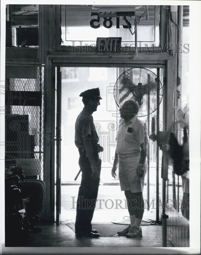 Press Photo Boston cop Harry Cataldo & a business owner - Historic Images