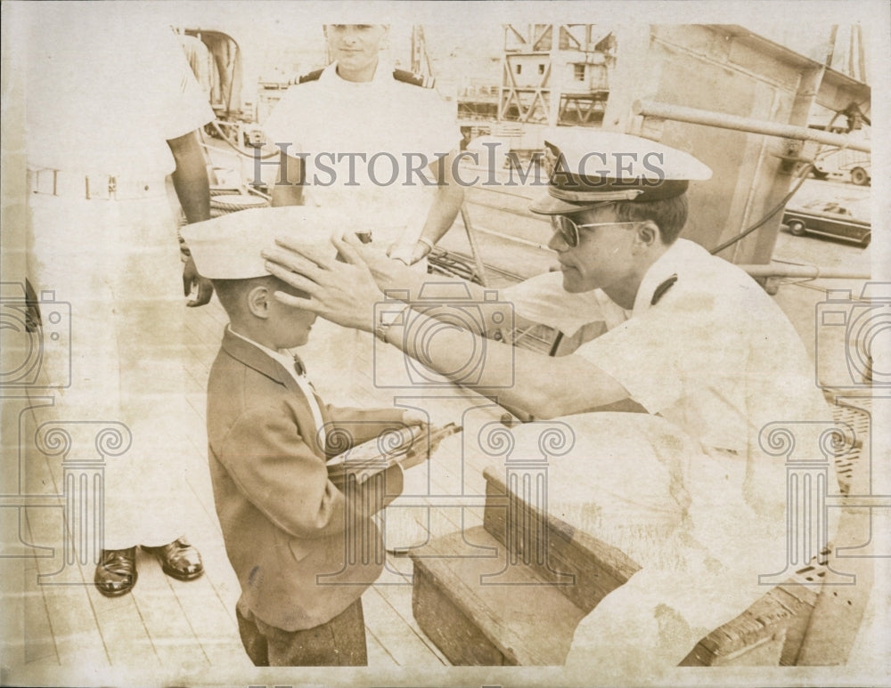 1966 Press Photo Dennis touring USS Boston gets cap squared by Charlie Powell - Historic Images