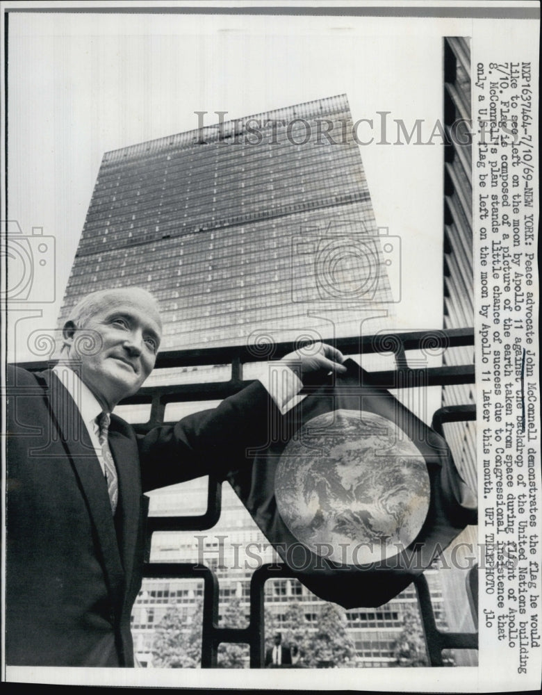 1969 Peace Advocate John McConnell, holds a flag to left on moon.-Historic Images