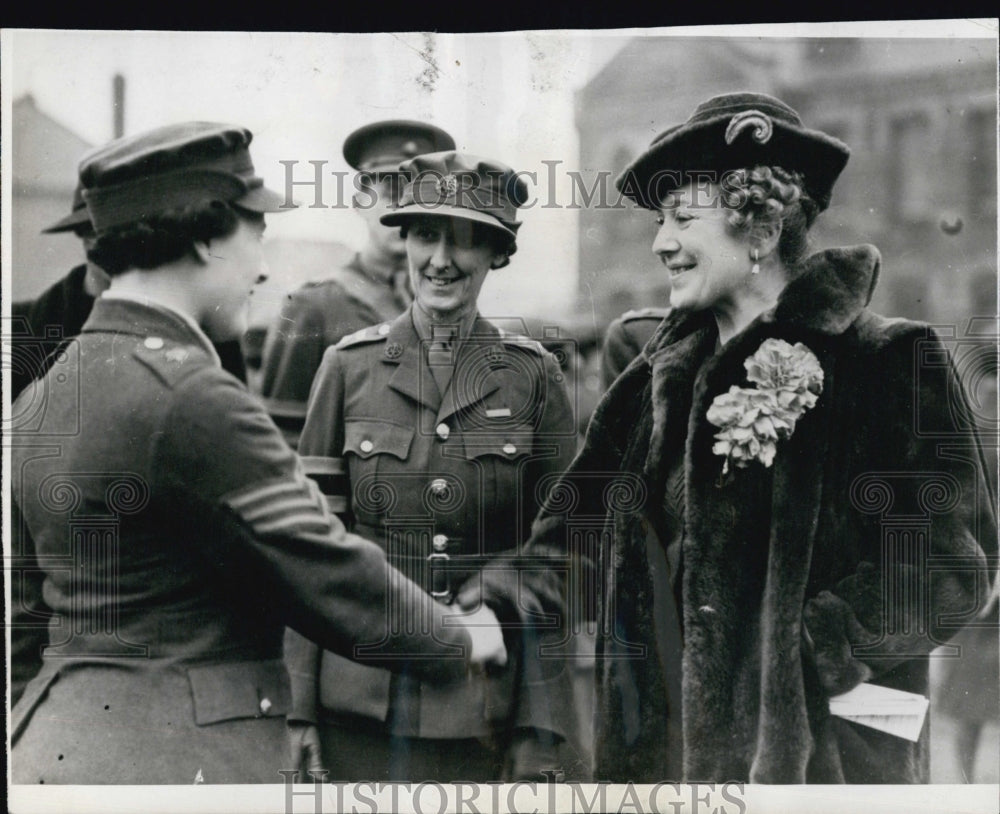 1939 Mrs.Nevile Chamberlain wife of the Premier hands with sergeant.-Historic Images