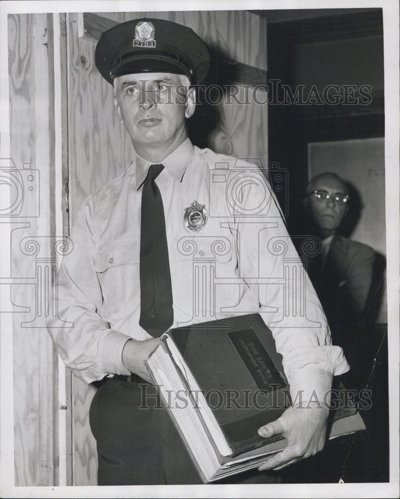 1956 Press Photo Police officer Edwin B Burke and records for a case - Historic Images