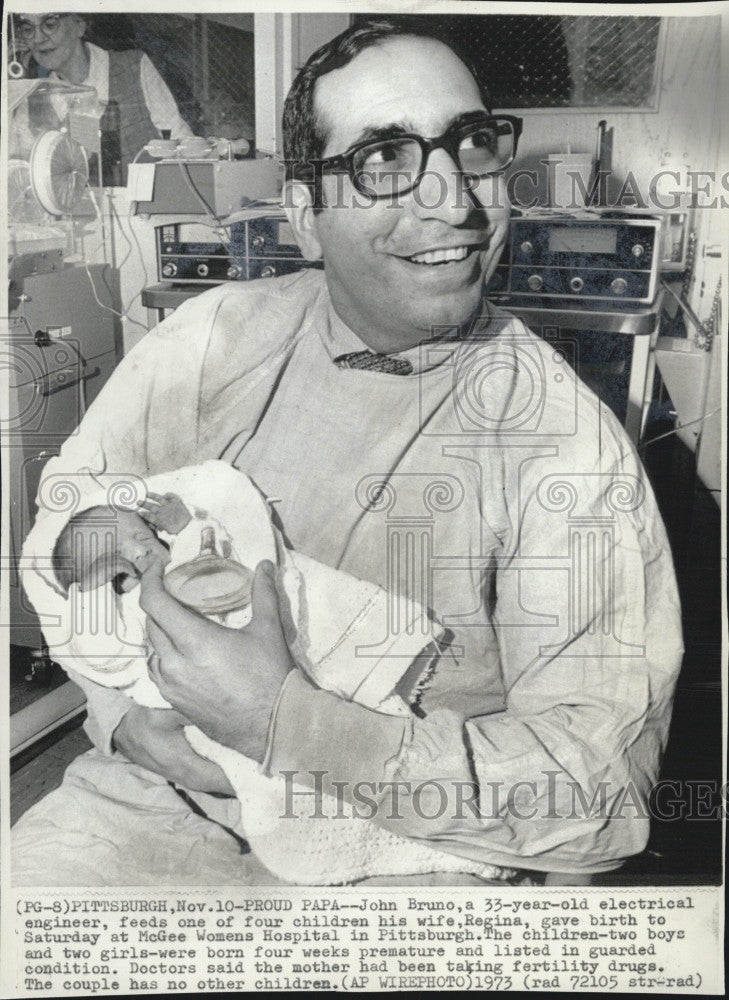 1973 Press Photo John Bruno feeds one of quadruplets his wife Regina gave birth - Historic Images