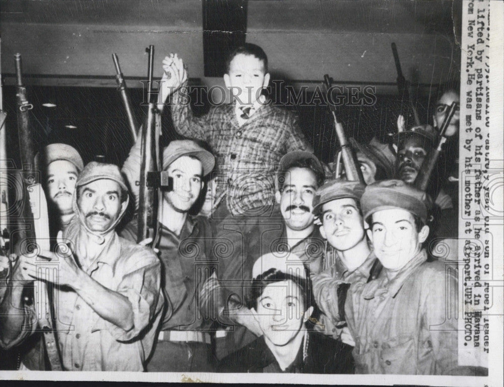 1959 Press Photo Fidelito Castro, son of Cuban leader, raised by Soldiers. - Historic Images