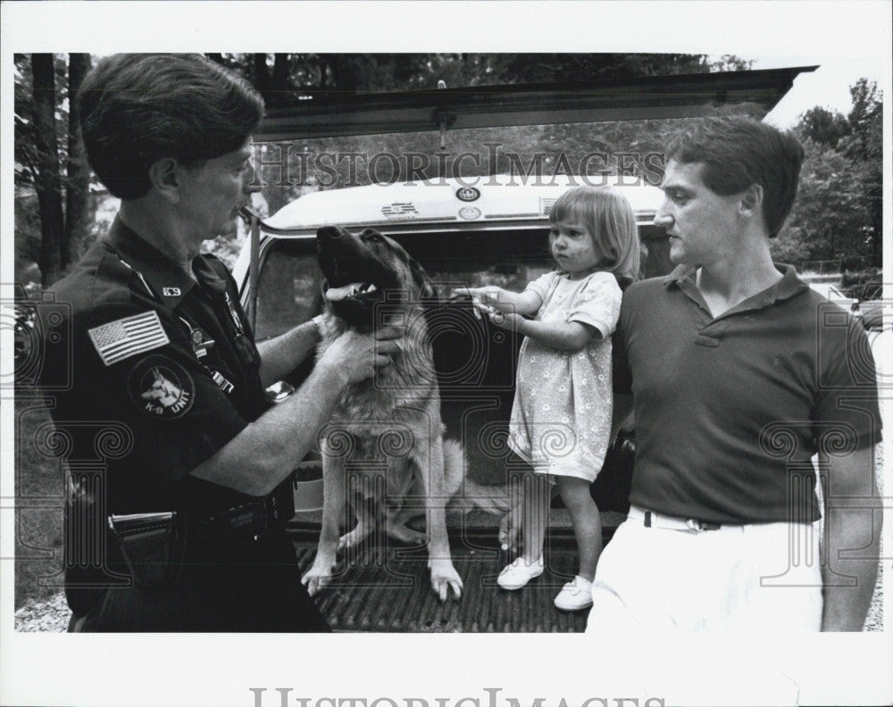 Press Photo Picture with police officer, a man, very young girl and German - Historic Images