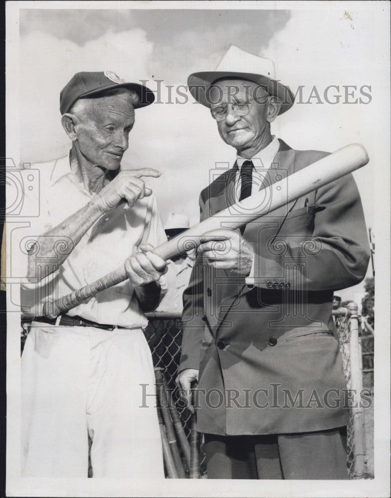 1955 Press Photo Bill Minto shows John Moriarty bat in Kads and Kubs game for - Historic Images