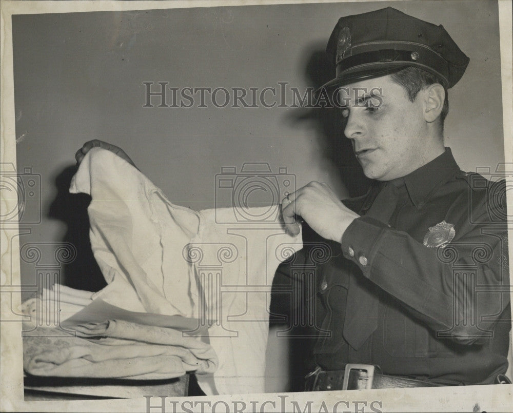 1957 Press Photo Officer Raymond Castro Checks Baby Boy X - Historic Images