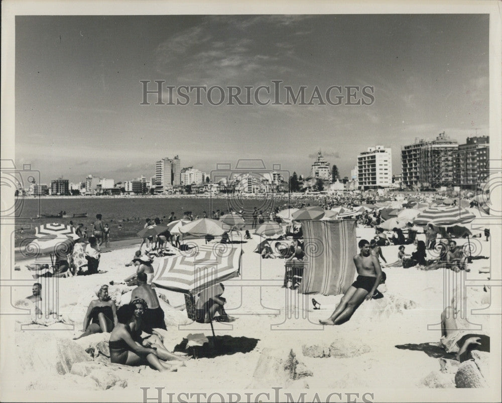 Press Photo Beach bathers in Uruguay with hotels in background - Historic Images