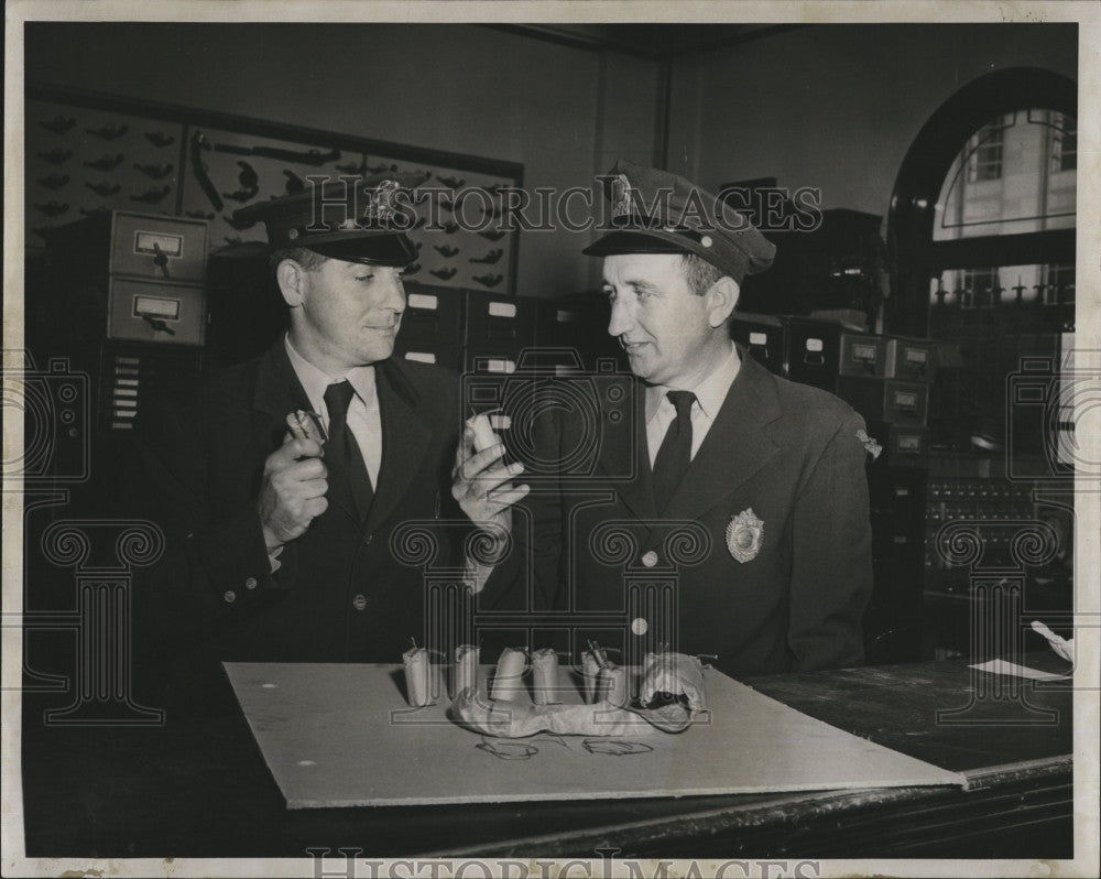 1957 Press Photo Boston cops with homemade bombs found on MTA bus - Historic Images