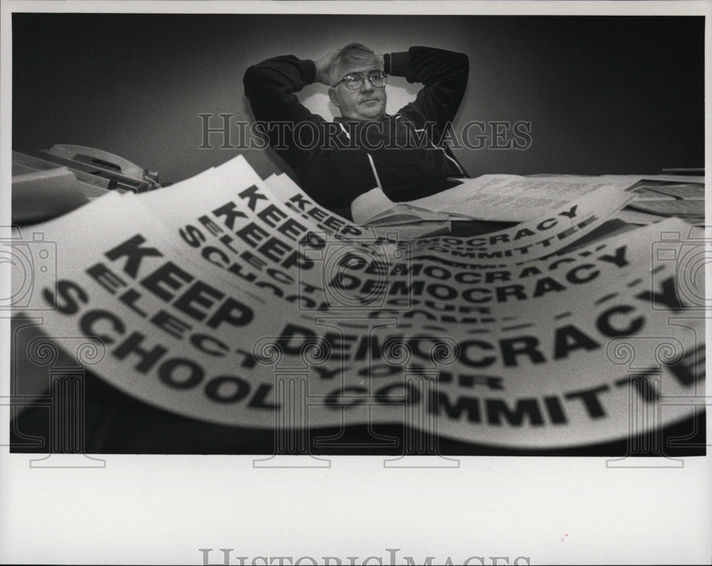 1992 Press Photo Don Burke,school committee with sticker at his office desk. - Historic Images