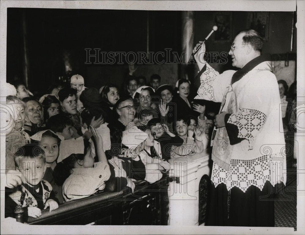 1954 Rev. Urban Maggio blessed children of the parish  - Historic Images