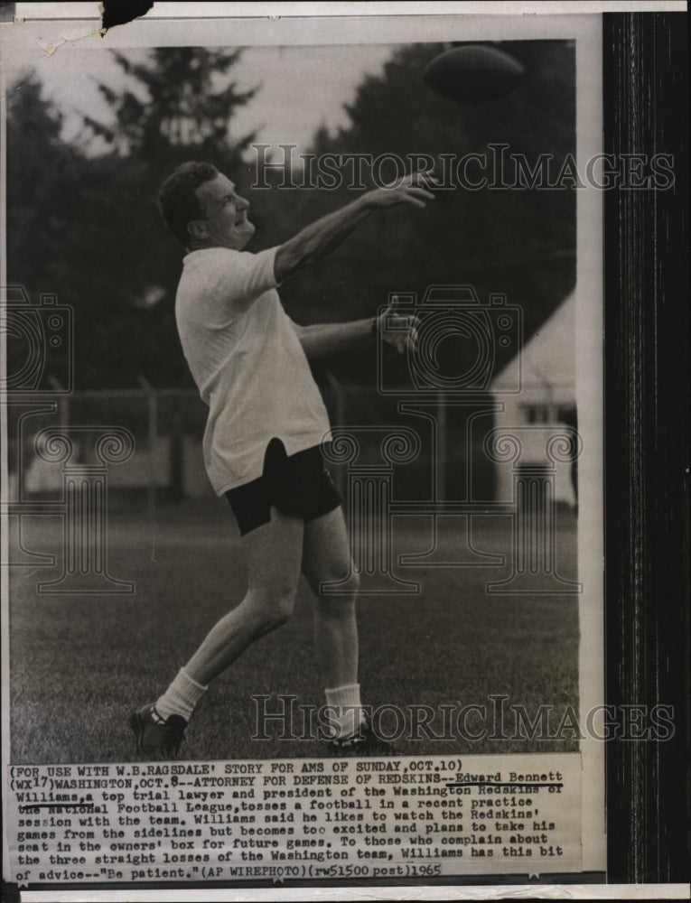 1965 Press Photo Edward Bennett,attorney relaxes tossing a football - RSM03745 - Historic Images