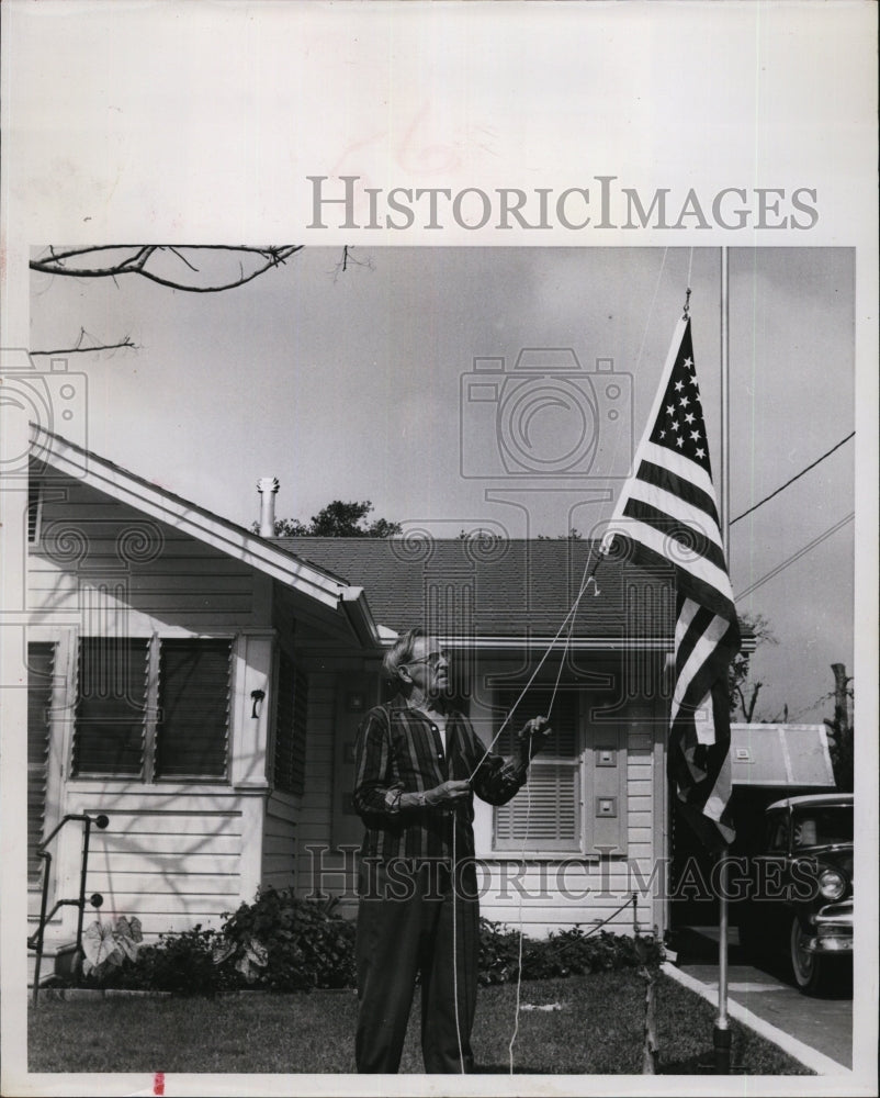 1963 Arthur H. Theroux raises his new US flag at his home - Historic Images