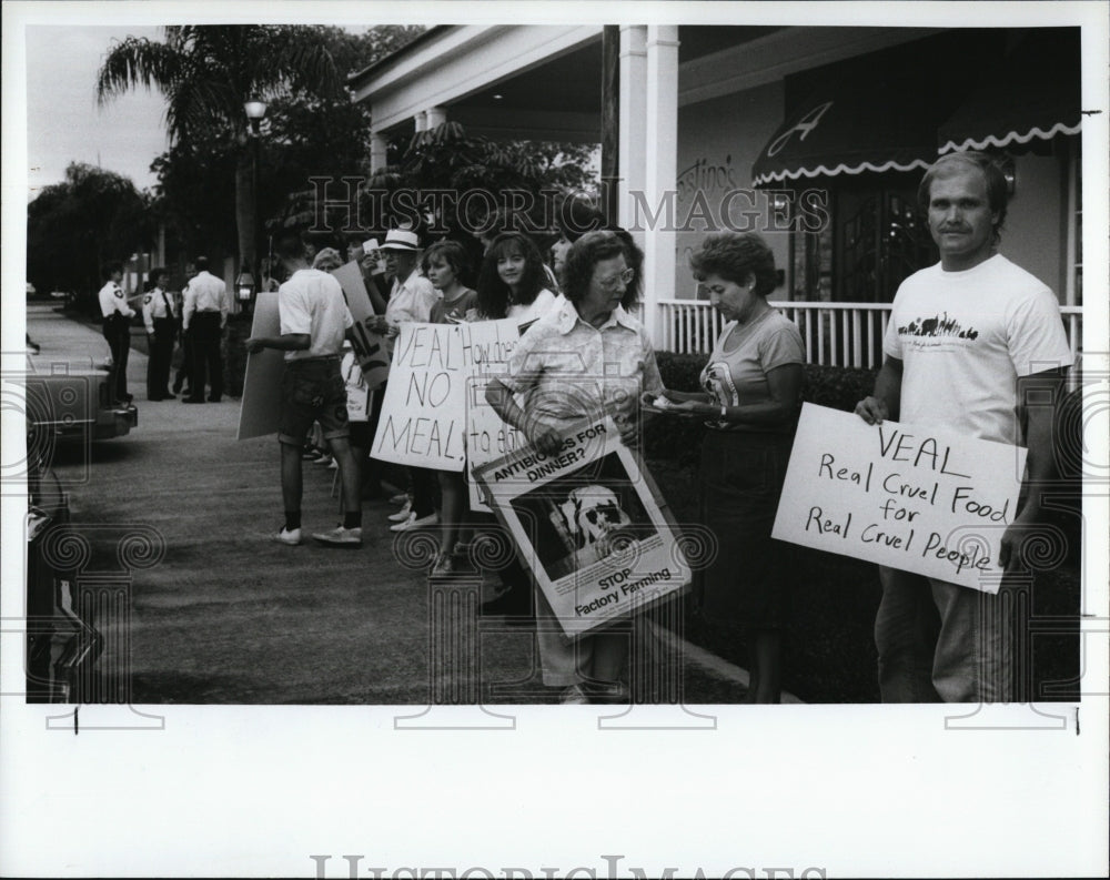 1990 Press Photo Protesters marching outside Agostino's Restaurant - Historic Images