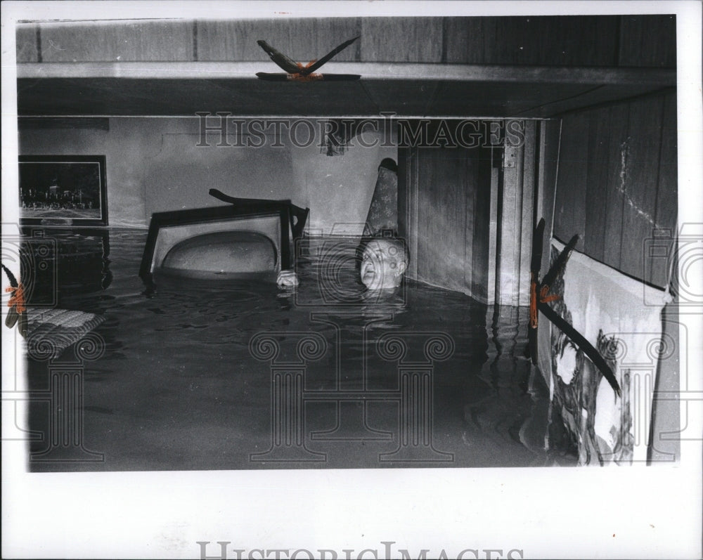 1972 Mr John McGill in his flooded basement in Detroit, Mich. - Historic Images