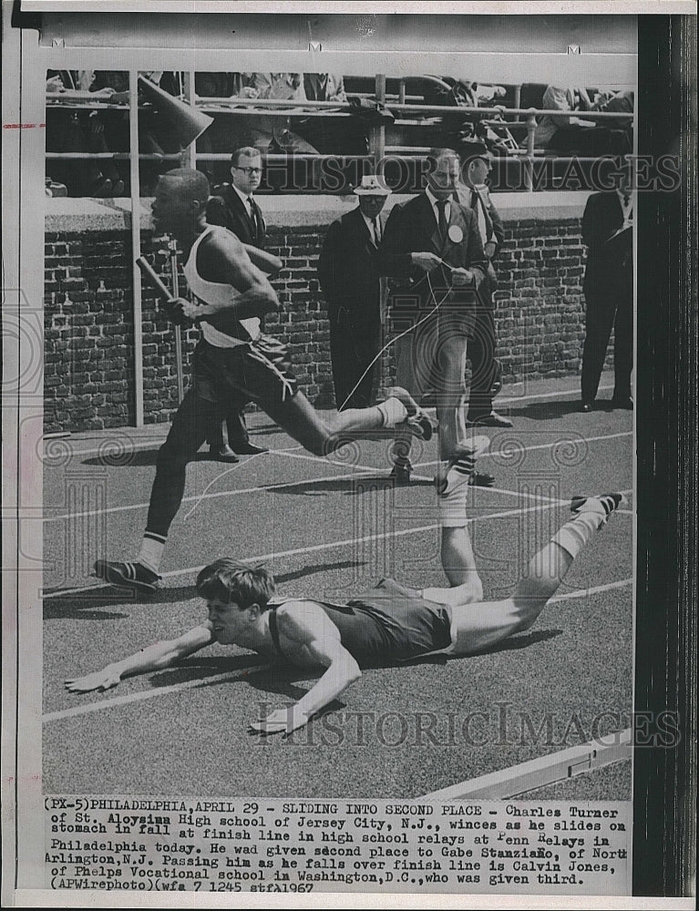 1967 Press Photo Charles Turner Slides into Finish line Penn Relays - Historic Images