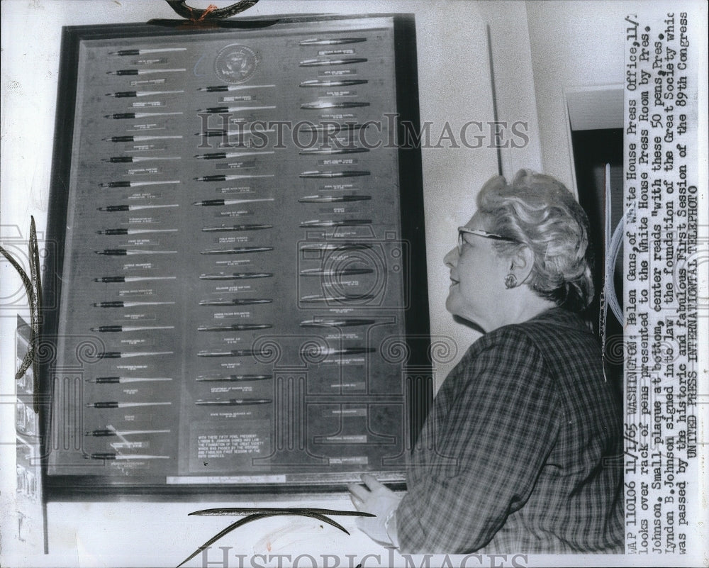 1965 Press Photo Helen Gans of the White House Press office looks over rack of - Historic Images