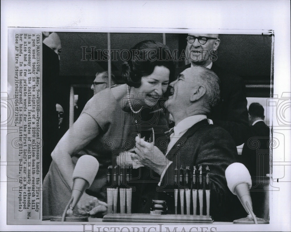 1965 Press Photo Pres Johnson hands the First Lady a pen he used in signing the - Historic Images