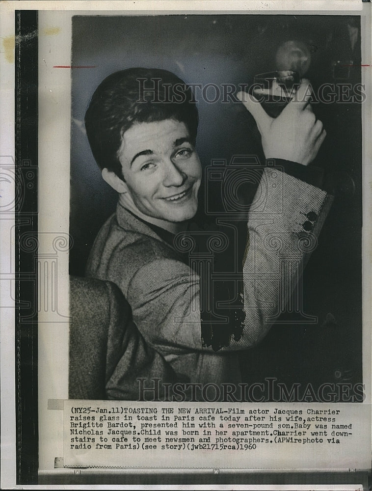 1960 Press Photo Jacques Charrier, French actor make a toast in Paris Cafe. - Historic Images