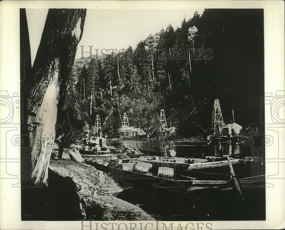 1964 Press Photo oil wells along a river bank - Historic Images