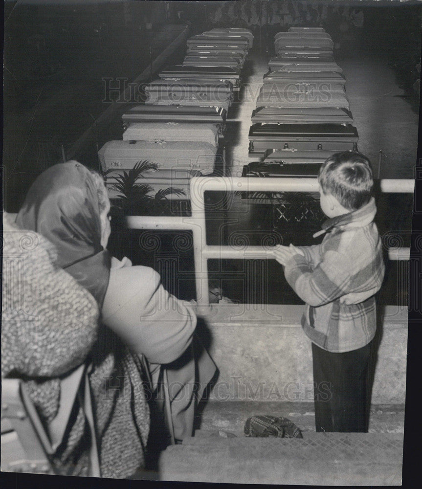1958 Small Boy Looks At Rows of Caskets - Historic Images