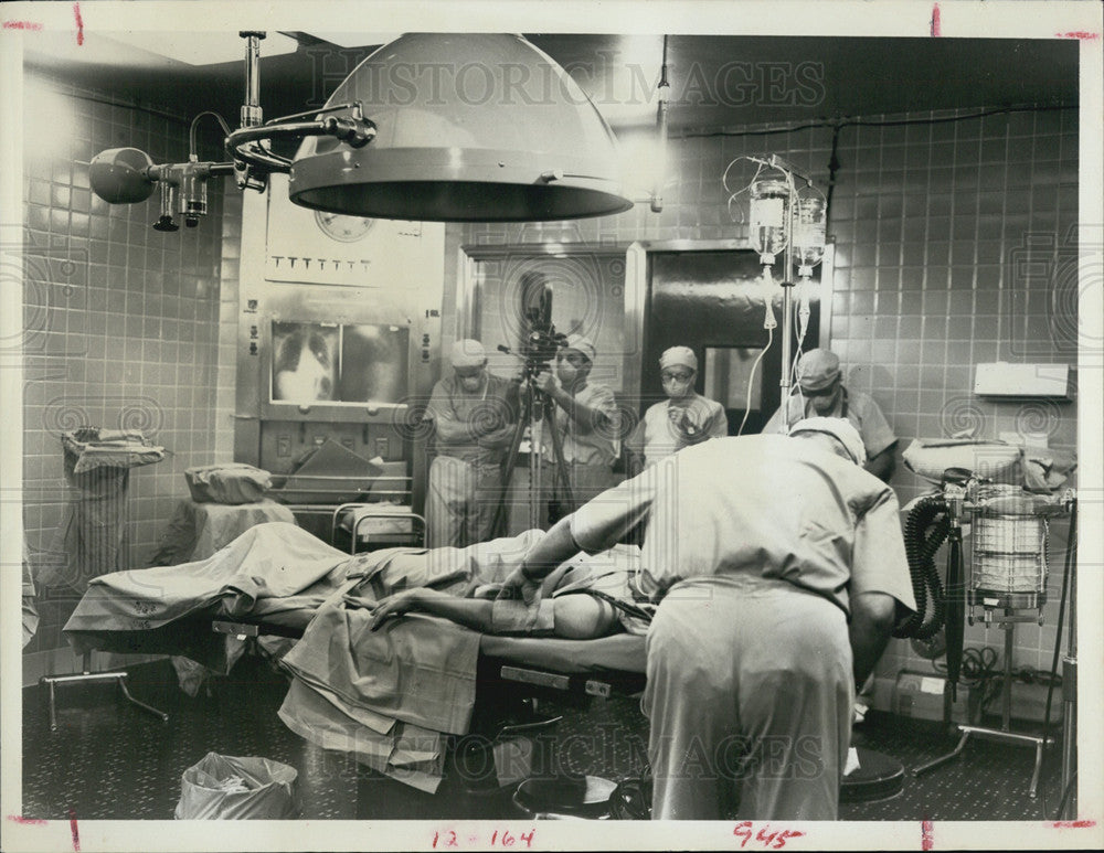 1968 Wounded soldier undergoing surgery in a field hospital - Historic Images