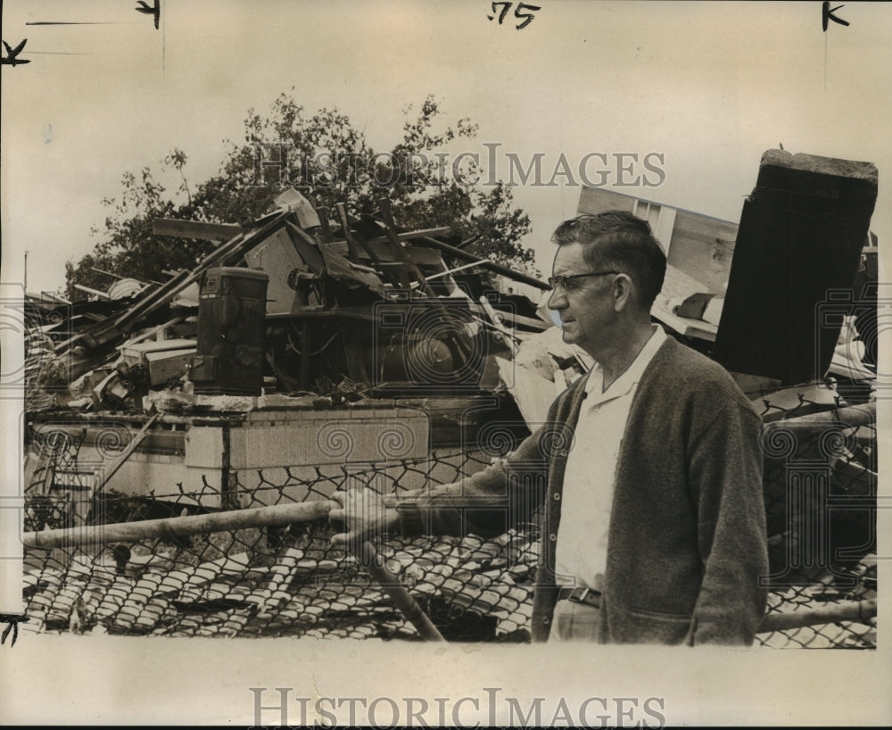 1967 Press Photo Man stands near downed fence &amp; surveys tornado damage, Alabama - Historic Images