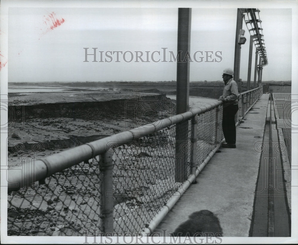 1975 Alabama-Worker examines the damage caused by Bouldin dam break.-Historic Images