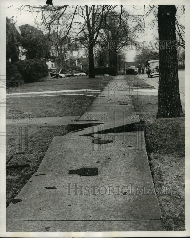 1954, Alabama tornado uprooted sidewalk in front of Birmingham home. - Historic Images