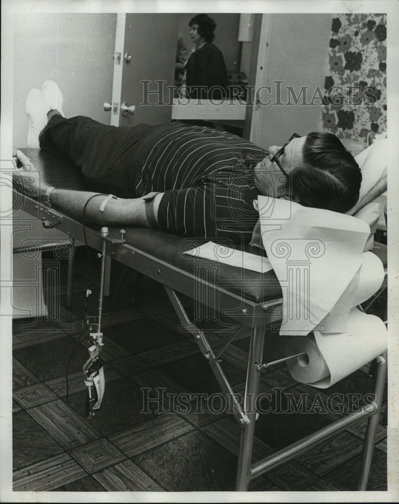 1973, Alabama man donates blood after devastating tornado hits. - Historic Images