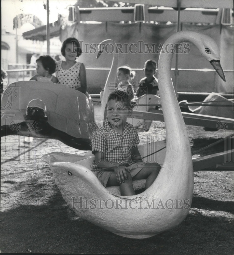 1960, Alabama-Child takes swan ride at Birmingham&#39;s Fair (Kiddieland) - Historic Images