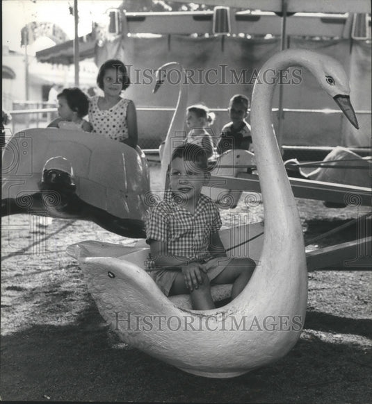1960, Alabama-Child takes swan ride at Birmingham's Fair (Kiddieland) - Historic Images
