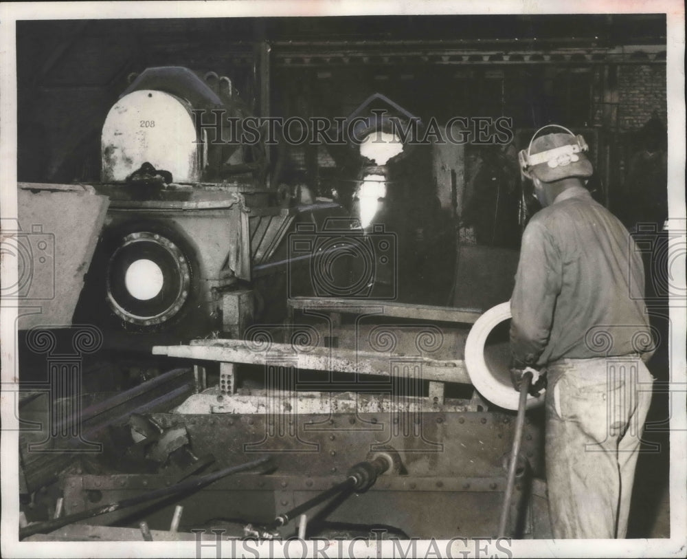 1956, Alabama-Birmingham, U.S. Pipe worker uses emery wheel on pipe. - Historic Images