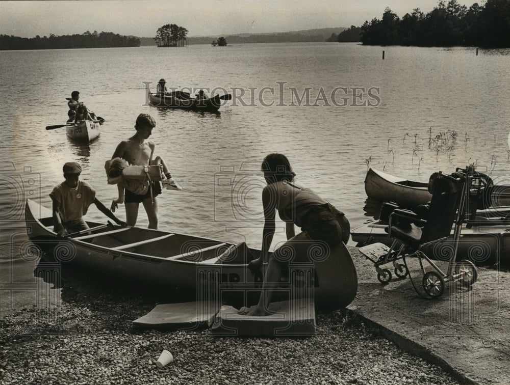 1984 Alabama-Ascca camp youth carries child back to wheel chair.-Historic Images
