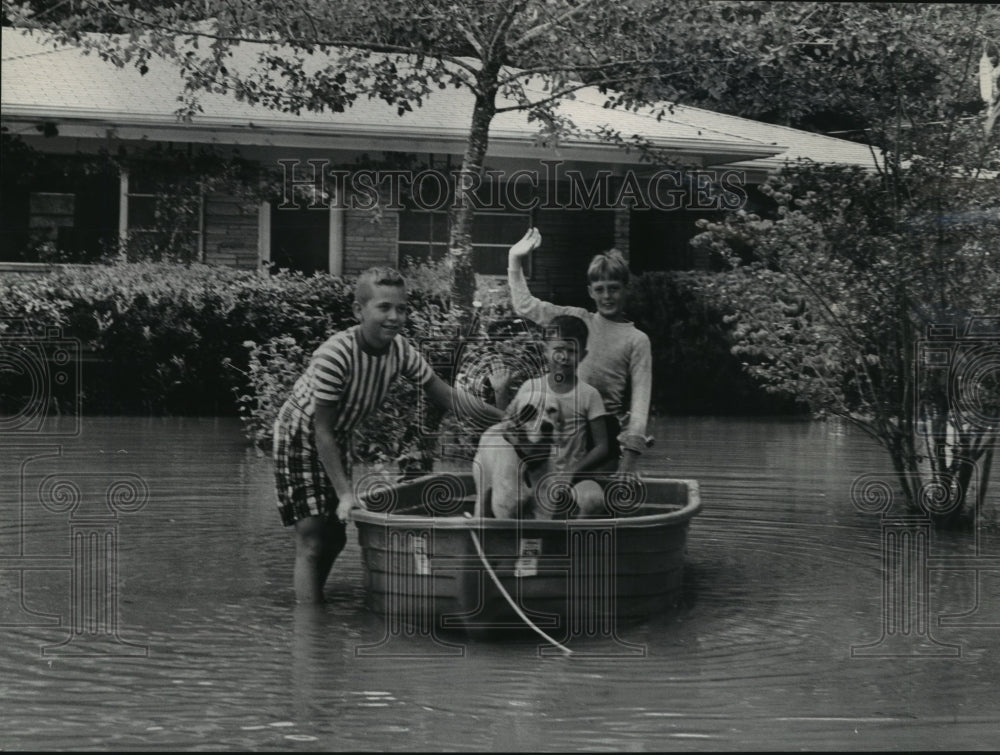 1967, Vernon Cotton, Carl Wilson, Roger Feazell play in flood waters - Historic Images